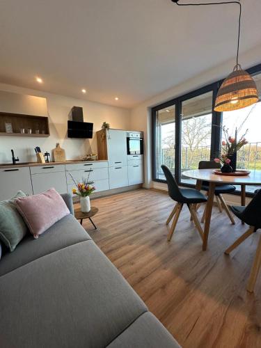 a living room with a couch and a table at Haus am See B&B in Bornheim