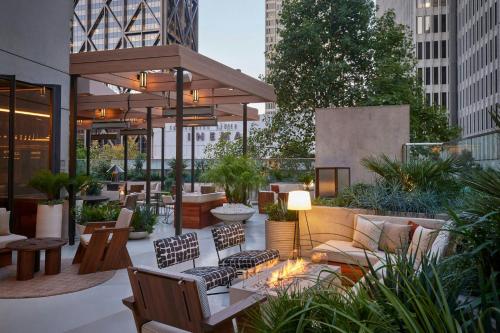 a patio with a couch and tables and chairs at The Jay, Autograph Collection in San Francisco