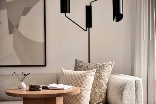 a living room with a couch and a table at The Jay, Autograph Collection in San Francisco