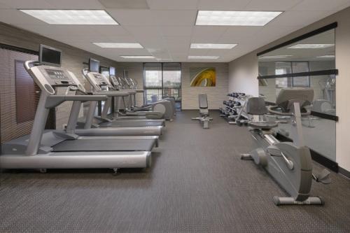 a gym with a row of treadmills and machines at Courtyard by Marriott Houston Northwest in Houston