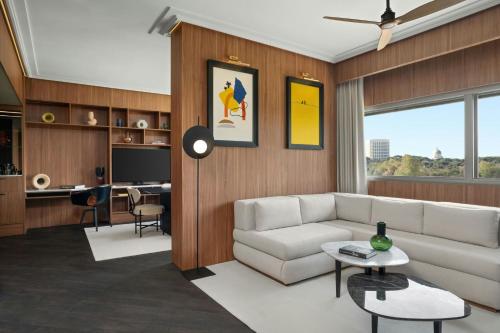 a living room with a couch and a table at Cardo Roma, Autograph Collection in Rome