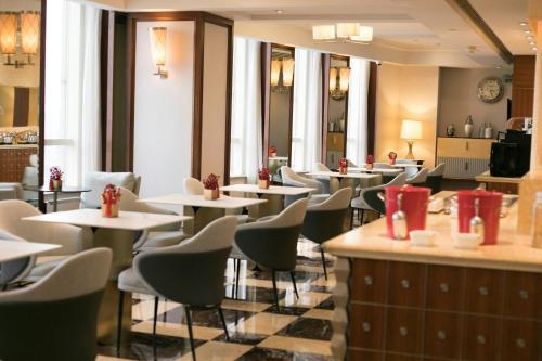 a restaurant with tables and chairs in a room at Renaissance Shanghai Pudong Hotel in Shanghai