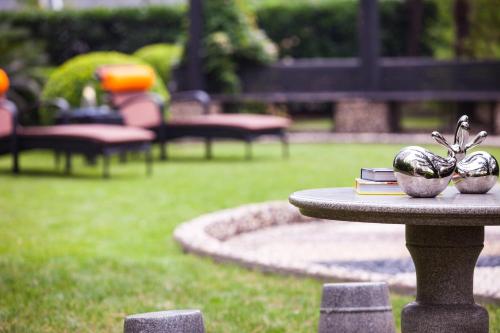 a table with books and statues on it in a park at Renaissance Shanghai Pudong Hotel in Shanghai