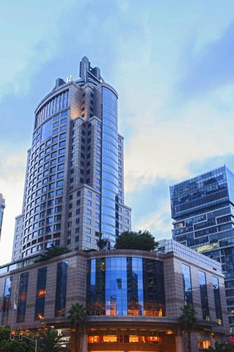 a tall building with a clock on the top of it at Renaissance Shanghai Pudong Hotel in Shanghai