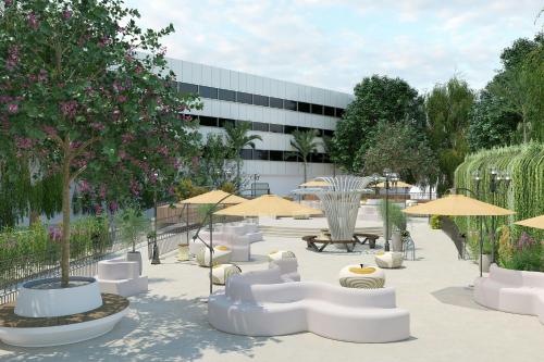 a courtyard with chairs and umbrellas and a building at Cardo Roma, Autograph Collection in Rome