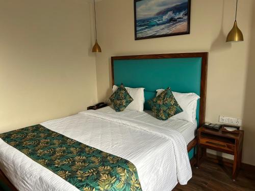 a bedroom with a large bed with a white bedspread at SeaScape Port Blair in Port Blair