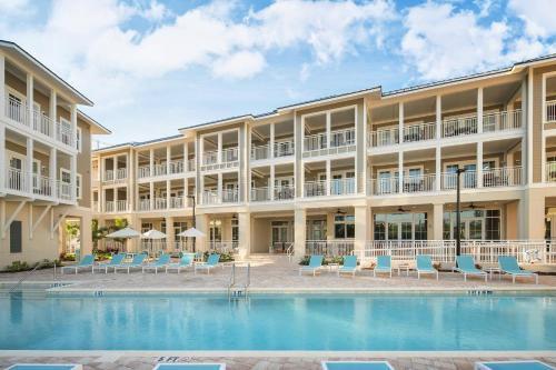 an exterior view of a hotel with a swimming pool at Waterline Villas & Marina, Autograph Collection in Holmes Beach