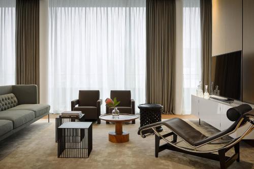 a living room with a couch and a table at Roomers Baden-Baden, Autograph Collection in Baden-Baden