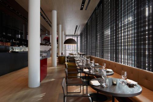a row of tables and chairs in a restaurant at Roomers Baden-Baden, Autograph Collection in Baden-Baden
