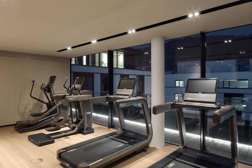 a gym with two tread machines and a laptop at Roomers Baden-Baden, Autograph Collection in Baden-Baden