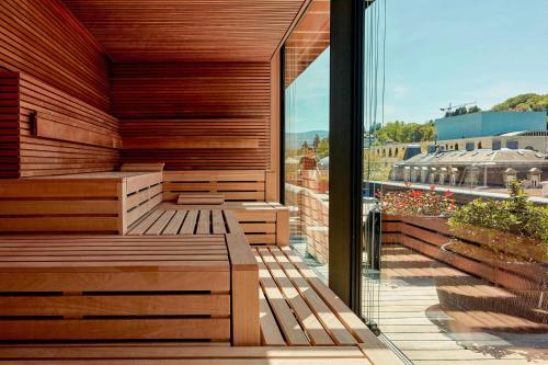 an outdoor sauna with a view of a building at Roomers Baden-Baden, Autograph Collection in Baden-Baden