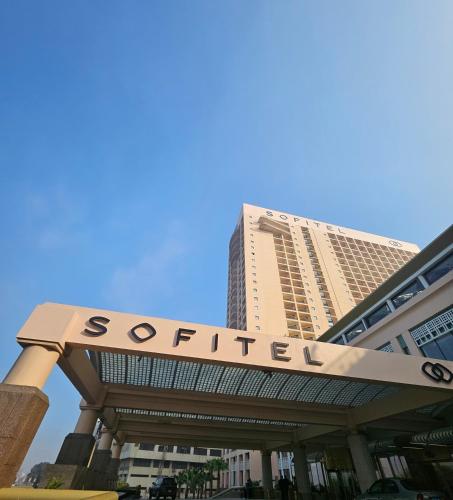 a building with a sign that reads serviced at Sofitel Cairo Downtown Nile in Cairo