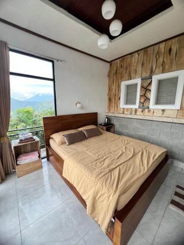 a bedroom with a large bed and a large window at Tukadsari camping in Kintamani