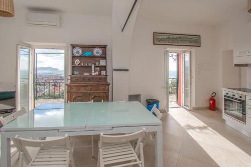 a kitchen with a table and chairs in a room at Le terrazze sul mare in Chiavari