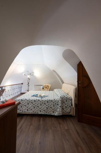 a bedroom with a bed in the middle of a room at La Cascina - Villa Nenno in Conca dei Marini