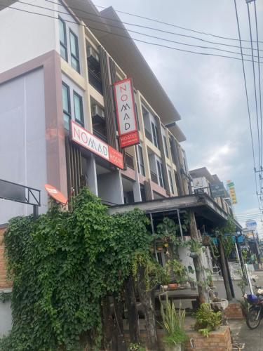 a building with a sign that reads no one at NOMAD HOSTEL KRABI AND TRAVEl in Krabi town