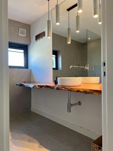a bathroom with a sink and a mirror at Casa Cordoama in Bordeira