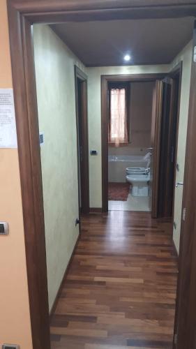 a hallway of a bathroom with a toilet and a sink at Emil apartment in Novara