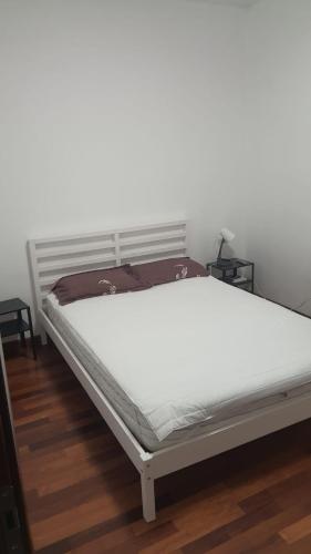 a bed in a room with a white mattress at Emil apartment in Novara