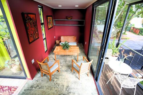 a patio with a wooden table and chairs at The Tree House in Johannesburg
