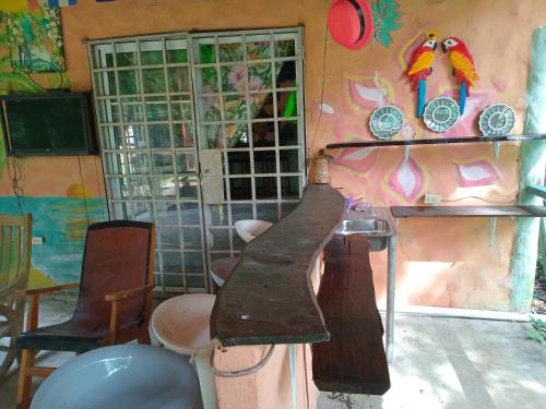 a room with a counter and a wall with paintings at Cabaña de Lucas in Loma Bonita