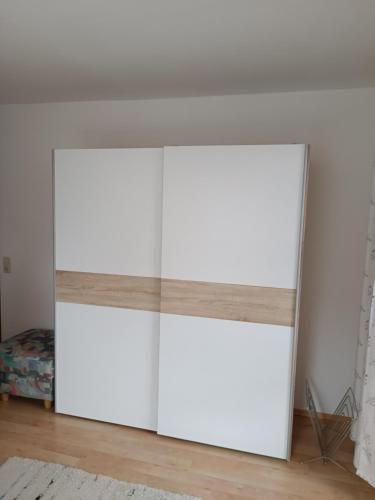 a pair of white wardrobes in a room at Ferienwohnung am Traunsee in Eck