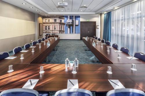 a conference room with a long table and chairs at Courtyard by Marriott Prague City in Prague