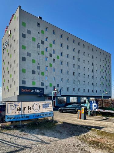 a building with a parking lot in front of it at Apartment Sofia Airport free shuttle and parking in Sofia