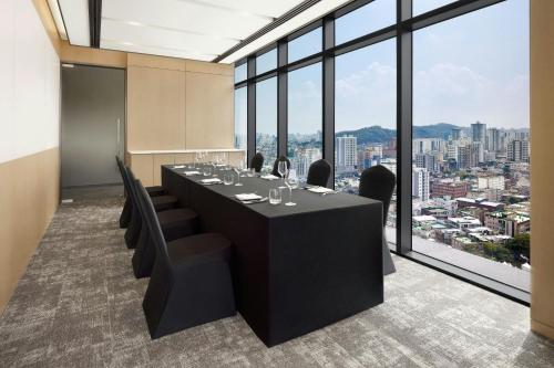 a conference room with a long table and chairs at AC Hotel by Marriott Seoul Geumjeong in Gunpo