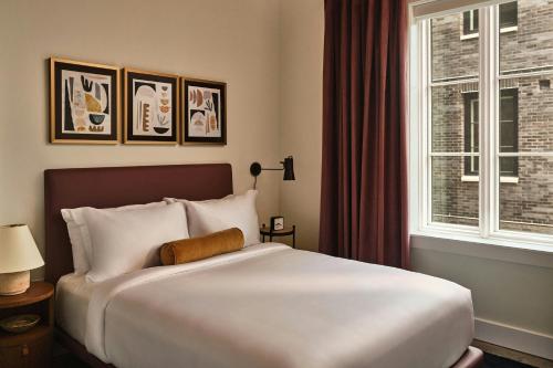 a bedroom with a large white bed and a window at The Ann Savannah, Apartments by Marriott Bonvoy in Savannah