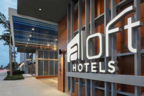a hotel sign on the side of a building at Aloft Fort Lauderdale Airport & Cruise Port in Fort Lauderdale