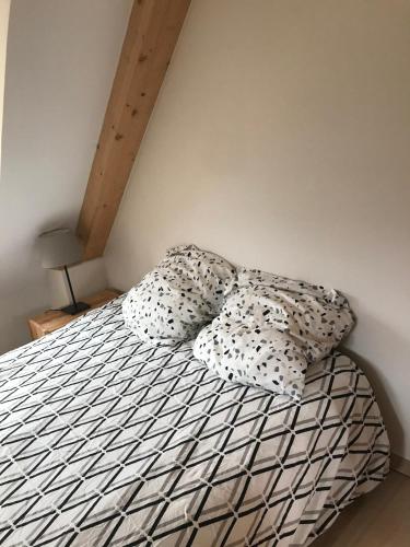 - un lit avec 2 oreillers dans une chambre dans l'établissement duplex neuf 3etoiles, à Le Mont-Dore