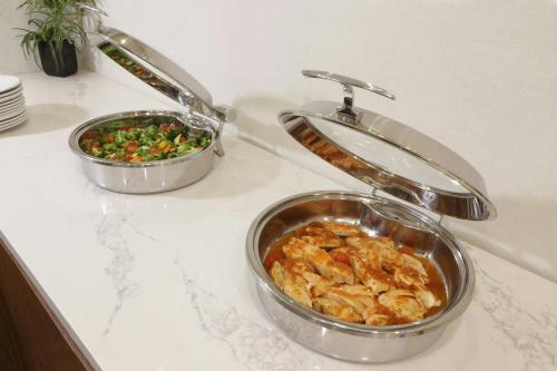 two dishes of food sitting on a counter next to a sink at Courtyard Monterrey Airport in Monterrey