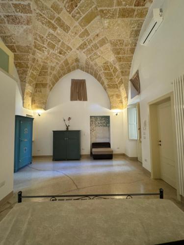a large room with a stone ceiling and a couch at Palazzo Ferilli Alfonso in Ruffano