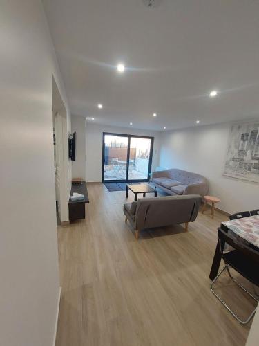 un salon avec un canapé et une table dans l'établissement Appartement avec terrasse dans la verdure, à Rueil-Malmaison