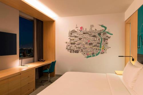 a bedroom with a map on the wall at Aloft Dubai Creek in Dubai