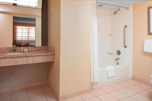 a bathroom with a shower and a sink at Courtyard by Marriott Killeen in Killeen