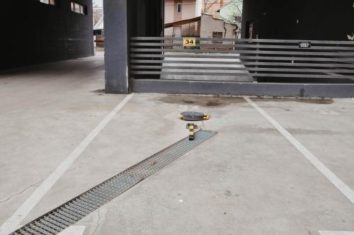 a skateboard sitting in the middle of a parking lot at PLAN Superior Apartment Niš, centar, FREE parking in Niš