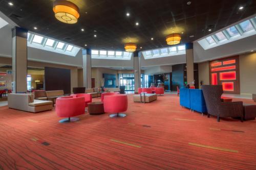 a lobby with red and blue chairs and tables at Courtyard by Marriott Killeen in Killeen