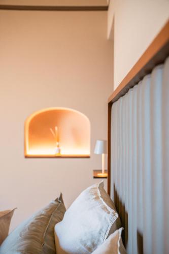 a bedroom with a bed with a clock on the wall at Antalia Boutique Hotel in Positano