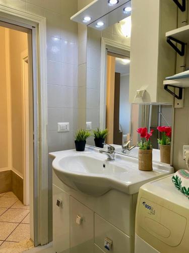 a bathroom with a sink and a mirror at Bnbook Lago Magico in Dormelletto