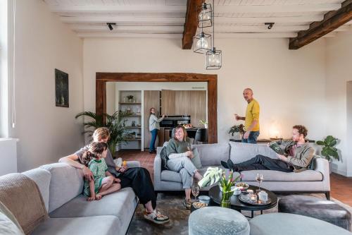 a group of people sitting in a living room at Beddermolen - Molenhuis op historisch erfgoeddomein in Westerlo
