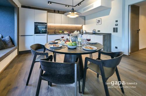een eetkamer en keuken met een tafel en stoelen bij BergHome in Garmisch-Partenkirchen