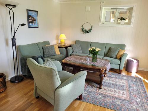 a living room with two couches and a coffee table at Irenegarden - Panorama apartment in Lauvstad
