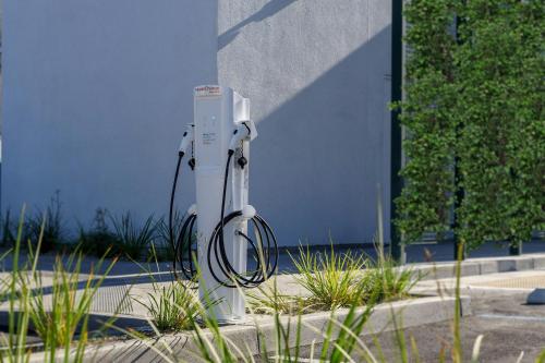 a white electric device sitting on the side of a building at AC Hotel by Marriott San Francisco Airport/Oyster Point Waterfront in South San Francisco