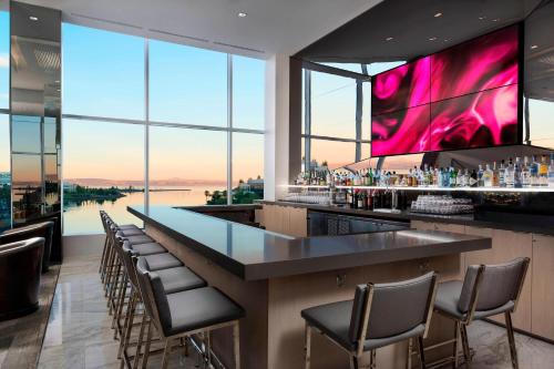a bar in a building with a view at AC Hotel by Marriott San Francisco Airport/Oyster Point Waterfront in South San Francisco