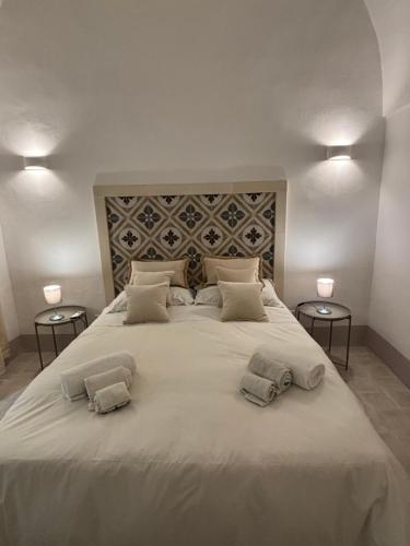 a large white bed with two pillows on it at La Casetta Casa Vacanze in Alessano