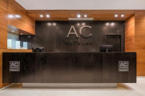 a reception desk in a building with aac sign at AC Hotel Palencia by Marriott in Palencia