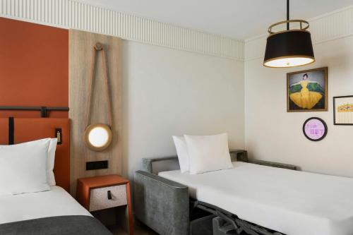 a room with two beds and a lamp at Imperial Riding School, Autograph Collection in Vienna