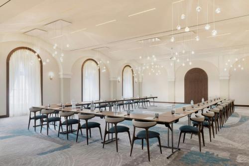 a large room with a long table and chairs at Imperial Riding School, Autograph Collection in Vienna